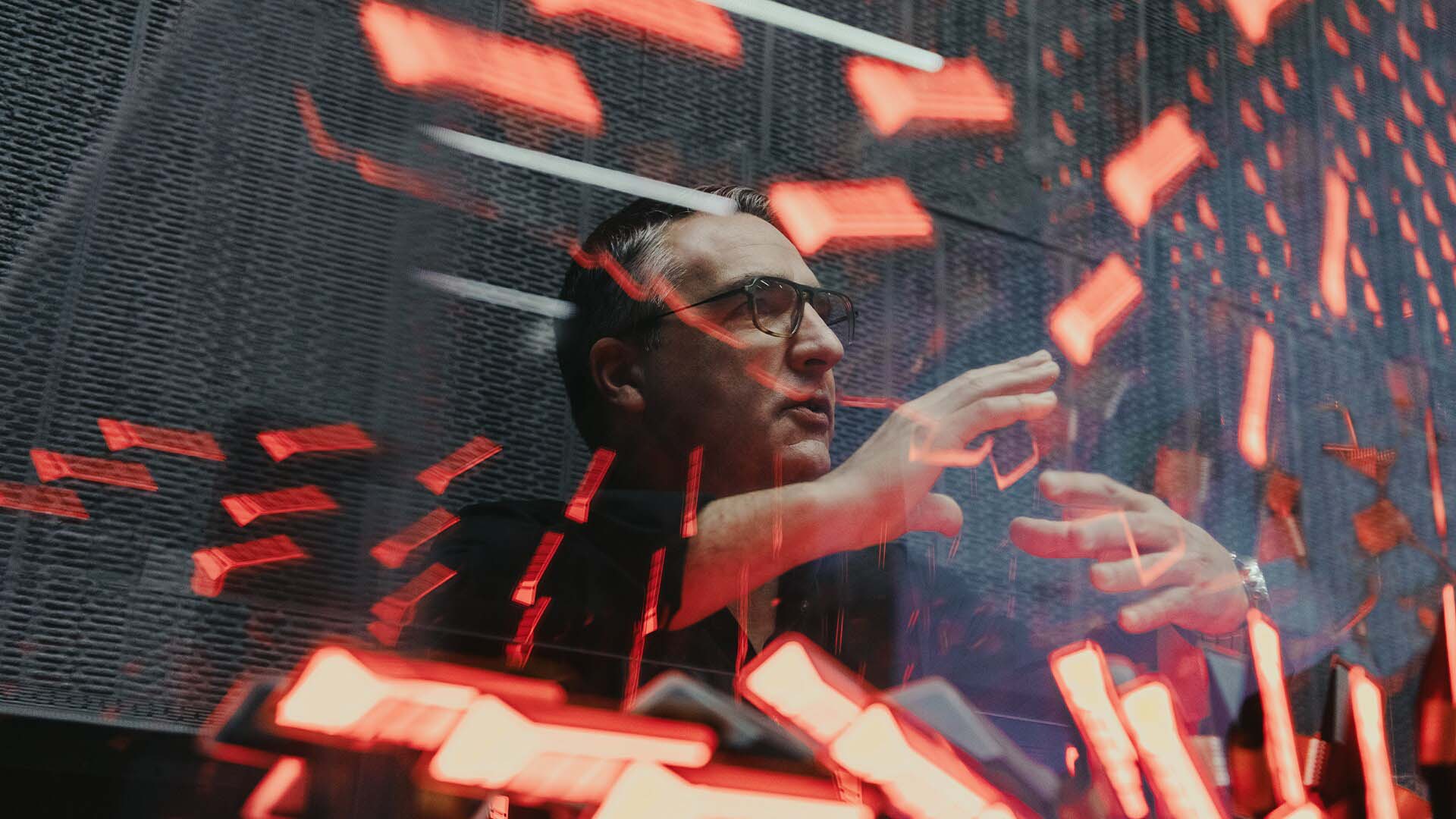 César Muntada behind light reflections.